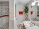 Clean basement bathroom with shower, tile flooring and decorative wallpaper at 655 Mcdonough Rd, Hampton, GA 30228