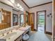 Bathroom with double vanity, access to private patio, and window view at 655 Mcdonough Rd, Hampton, GA 30228