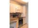 Kitchen boasting white cabinets and stainless steel appliances at 12 Intown Pl, Fayetteville, GA 30214
