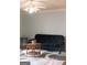Living room featuring a futon, coffee table, and ceiling fan at 12 Intown Pl, Fayetteville, GA 30214