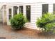 White exterior with landscaping and small bushes at 12 Intown Pl, Fayetteville, GA 30214