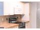 Modern kitchen with stainless steel appliances and white cabinets at 12 Intown Pl, Fayetteville, GA 30214
