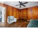 Living room with wood paneling and comfy seating at 409 N Green Cir, Mcdonough, GA 30252