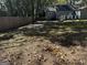 Large backyard with a partially paved area and wooden fence at 1901 Maywood Nw Pl, Atlanta, GA 30318
