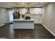 Modern kitchen with island, white cabinets, and dark floors at 1901 Maywood Nw Pl, Atlanta, GA 30318