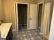 Bathroom with patterned floor, double vanity, and adjacent closet at 1901 Maywood Nw Pl, Atlanta, GA 30318