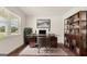 Home office with glass desk, large bookcase, and hardwood floors at 660 Edgar St # 158, Hampton, GA 30228