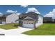 Two-story house with a white two-car garage and landscaped lawn at 660 Edgar St # 158, Hampton, GA 30228