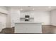 Modern kitchen with white cabinets and island at 660 Edgar St # 158, Hampton, GA 30228