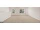 Spacious bedroom with large windows and neutral carpeting at 660 Edgar St # 158, Hampton, GA 30228