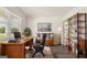 Modern home office with wood desk and floor to ceiling shelving at 660 Edgar St # 158, Hampton, GA 30228