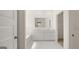 Bathroom with double vanity, bathtub, and walk-in closet at 660 Edgar St # 158, Hampton, GA 30228