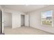 Well-lit bedroom with closet and neutral carpeting at 660 Edgar St # 158, Hampton, GA 30228