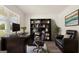Dark wood home office features a couch and built-in shelving at 660 Edgar St # 158, Hampton, GA 30228