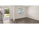 Spacious living room with hardwood floors and a large window at 660 Edgar St # 158, Hampton, GA 30228