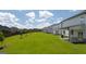 Community backyard with lush lawn and townhomes at 660 Edgar St # 158, Hampton, GA 30228