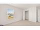 Bright bedroom with window, closet, and neutral carpeting at 660 Edgar St # 158, Hampton, GA 30228
