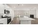 Open concept kitchen features island, stainless steel appliances, and gas range at 660 Edgar St # 158, Hampton, GA 30228
