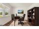 Home office with wood desk, chair, and built-in shelving at 660 Edgar St # 158, Hampton, GA 30228