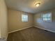 Well-lit bedroom with neutral walls and carpeted floors at 4466 Merlin Dr, Douglasville, GA 30134