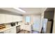 Bright kitchen with white cabinets, stainless steel appliances, and a door to outside at 36 Intown Pl, Fayetteville, GA 30214