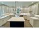 Modern kitchen with island, white cabinets, and hardwood floors at 1471 Centennial Rd, Rutledge, GA 30663