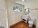 Updated bathroom with white vanity, frameless shower, and wood-look floors at 1471 Centennial Rd, Rutledge, GA 30663