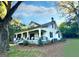 Farmhouse with wrap-around porch and landscaping at 1471 Centennial Rd, Rutledge, GA 30663