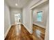 Hallway with hardwood floors, offering views of the kitchen and other rooms at 1471 Centennial Rd, Rutledge, GA 30663