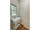 Laundry room with utility sink and wood flooring at 1471 Centennial Rd, Rutledge, GA 30663