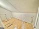 Unfinished attic space with plywood flooring and access doors at 1471 Centennial Rd, Rutledge, GA 30663