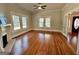 Spacious living room featuring hardwood floors, fireplace, and large windows at 1471 Centennial Rd, Rutledge, GA 30663