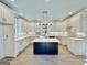 Modern kitchen with island, white cabinets, and hardwood floors at 1471 Centennial Rd, Rutledge, GA 30663