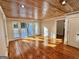 Bright living room features hardwood floors and wood ceiling at 1471 Centennial Rd, Rutledge, GA 30663