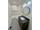 Clean bathroom with a single vanity, tub, and patterned floor tiles at 1471 Centennial Rd, Rutledge, GA 30663