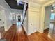 Long hallway with hardwood floors and staircase at 1471 Centennial Rd, Rutledge, GA 30663