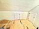 Unfinished attic space with plywood flooring and access doors at 1471 Centennial Rd, Rutledge, GA 30663