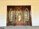 Detailed view of antique wooden front door with oval glass panels at 1471 Centennial Rd, Rutledge, GA 30663