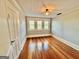 Bright bedroom with hardwood floors and three windows at 1471 Centennial Rd, Rutledge, GA 30663