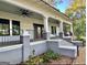 Large front porch with grey columns, black railing, and ceiling fans at 1471 Centennial Rd, Rutledge, GA 30663