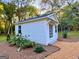White detached studio with double doors and landscaping at 1471 Centennial Rd, Rutledge, GA 30663
