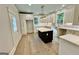 Modern kitchen with island, white cabinets, and hardwood floors at 1471 Centennial Rd, Rutledge, GA 30663