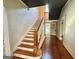 Grand staircase with wooden railings and hardwood floors at 1471 Centennial Rd, Rutledge, GA 30663
