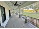 Spacious back porch with wooden flooring, black railing, and ceiling fan at 1471 Centennial Rd, Rutledge, GA 30663