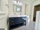 Renovated bathroom with double vanity, patterned tile floor, and a walk-in shower at 1471 Centennial Rd, Rutledge, GA 30663