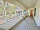 Relaxing screened porch with wood flooring and wooded views at 1471 Centennial Rd, Rutledge, GA 30663