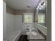 Clean bathroom with white tile, granite vanity and tub at 2164 Rockhaven Cir, Decatur, GA 30032