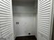 Laundry closet with built-in shelving and hookups at 2164 Rockhaven Cir, Decatur, GA 30032