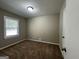 Spacious bedroom with carpeted floors and large window at 2164 Rockhaven Cir, Decatur, GA 30032