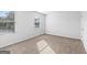 Well-lit bedroom featuring neutral carpeting and a window at 319 Granary Walk # 92, Covington, GA 30014